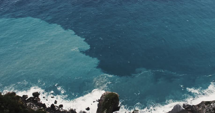 Waves wash up along the rocks