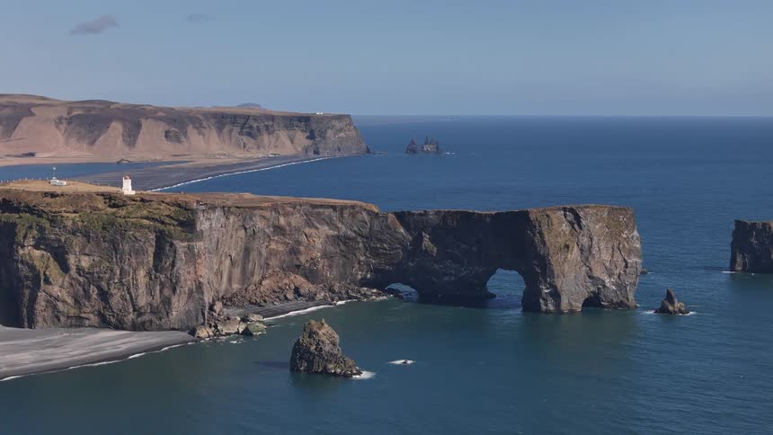 A large promontory sticks out into the ocean