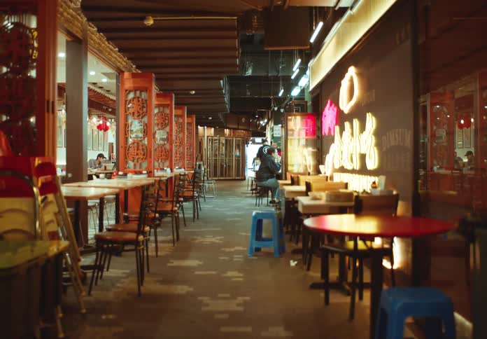 A person sits at the counter at a restaurant