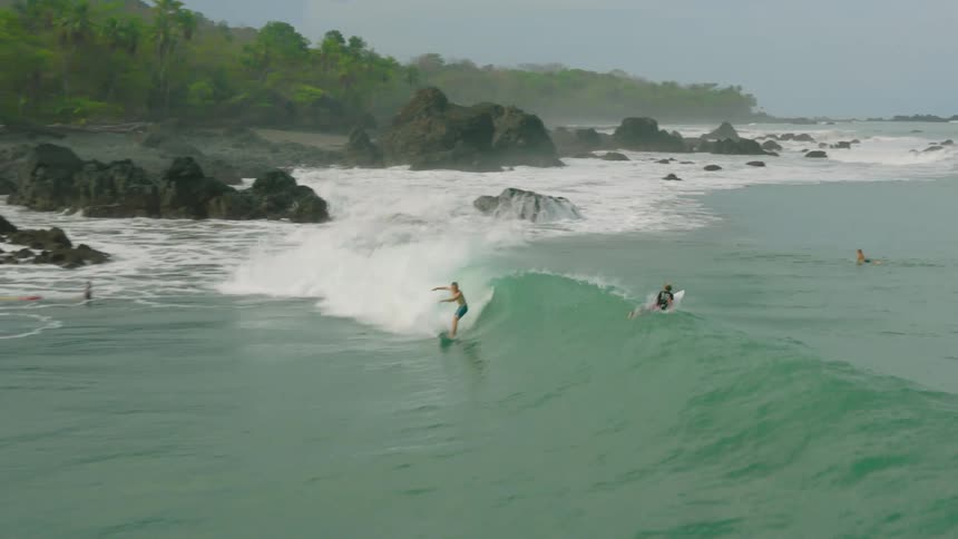 People are surfing near the shore