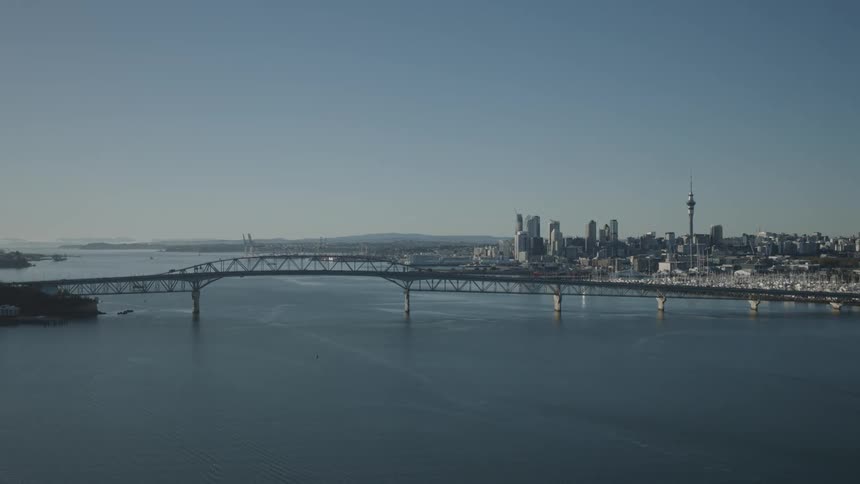 A large bridge crossing the sea and leading to a big city