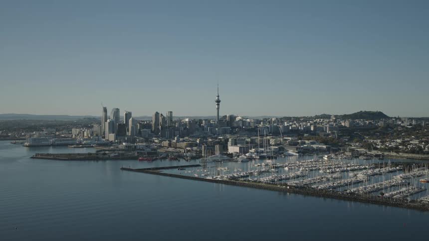 A city near a sea coast with a port full of docked boats