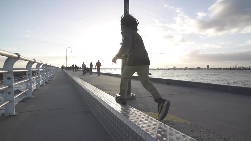 Child running alongside the water
