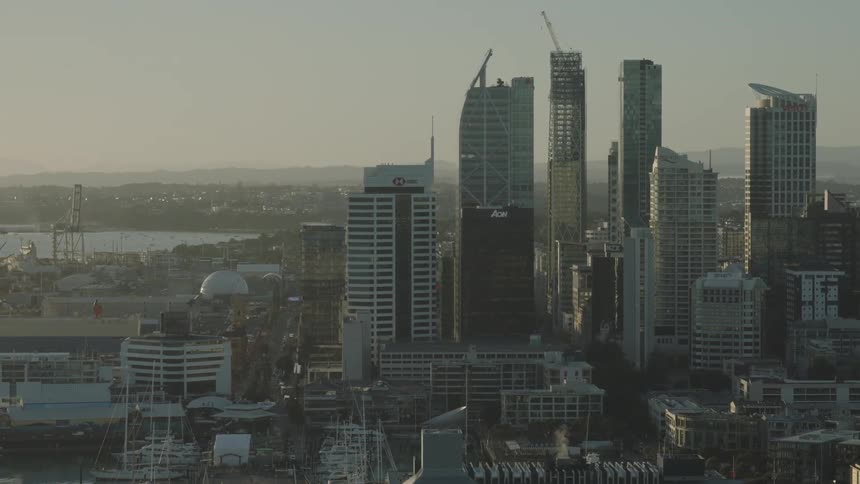 Aerial view of a modern city skyline with highrise buildings at sunset