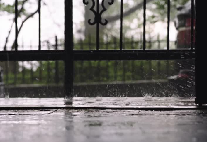 A person walks in the pouring rain