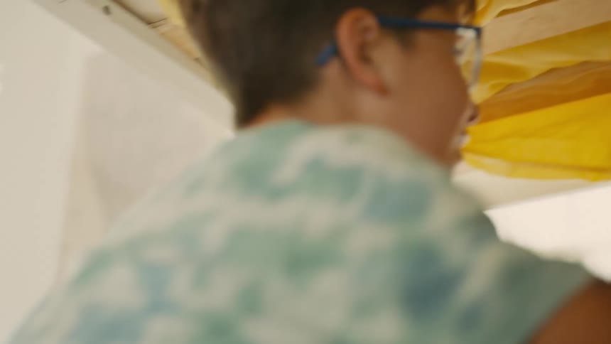 A boy stacks stuffed animals on his friend