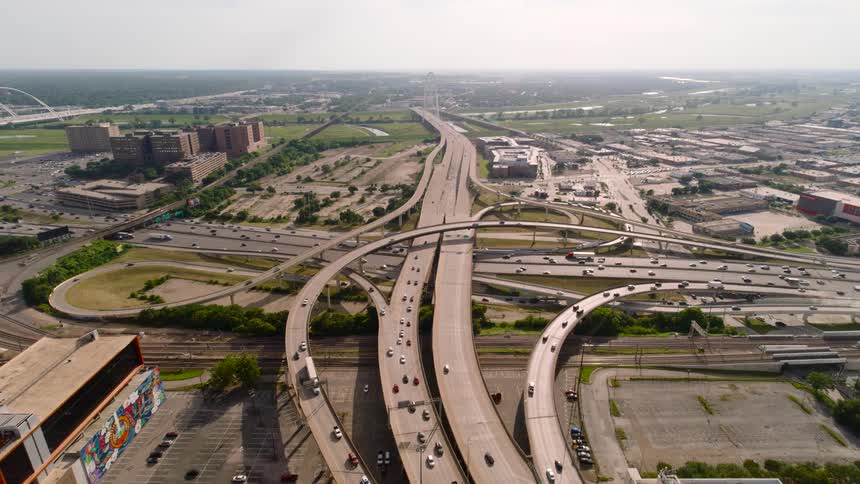 Traffic moves near exits on an interstate through a city