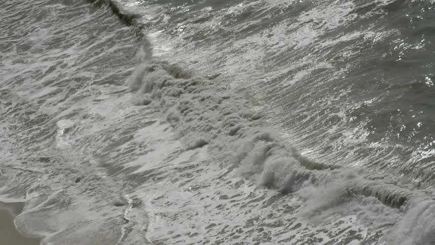 Waves crash against the shore on this beach