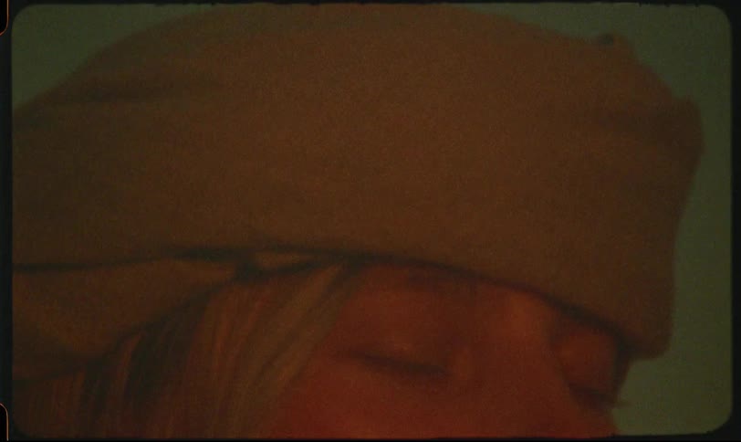 Pair of hands tying turban on blonde womans head