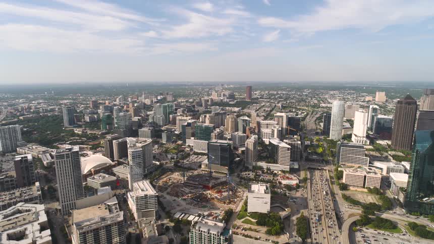 A large city with many buildings and heavy traffic on the road