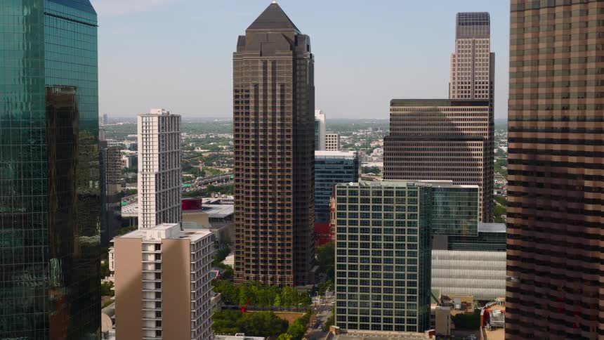 Aerial view of a dense downtown skyline filled with modern highrise buildings during daylight