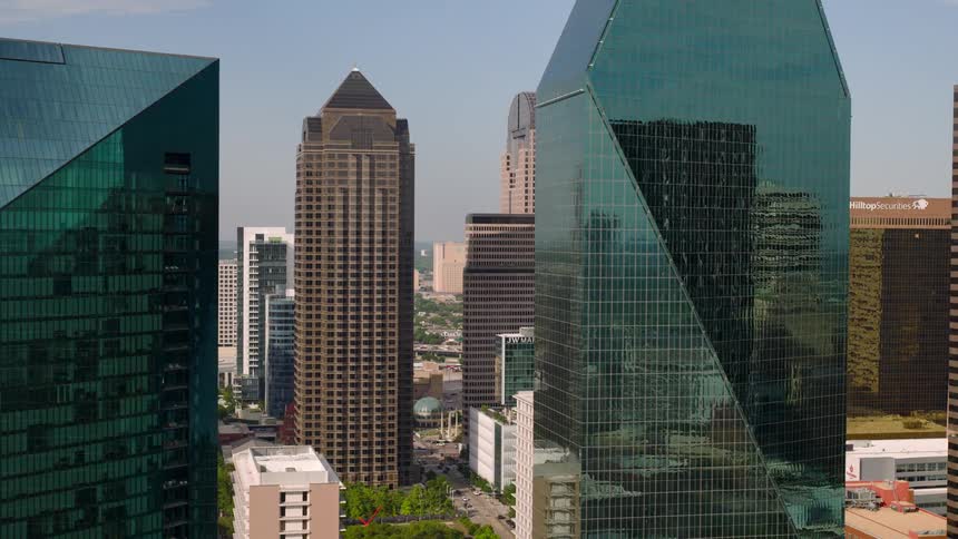 Closeup aerial shot of modern glass skyscrapers in a downtown business district during daylight
