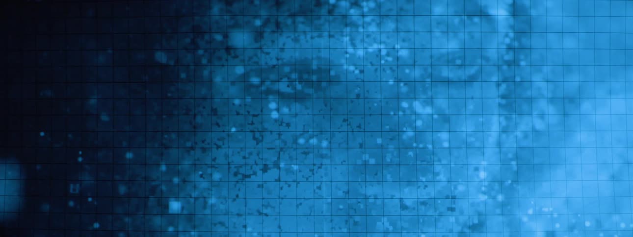 A face forms on a textured blue surface with a grid pattern is partially obscured by a darker pixelated gradient and scattered light blue squares