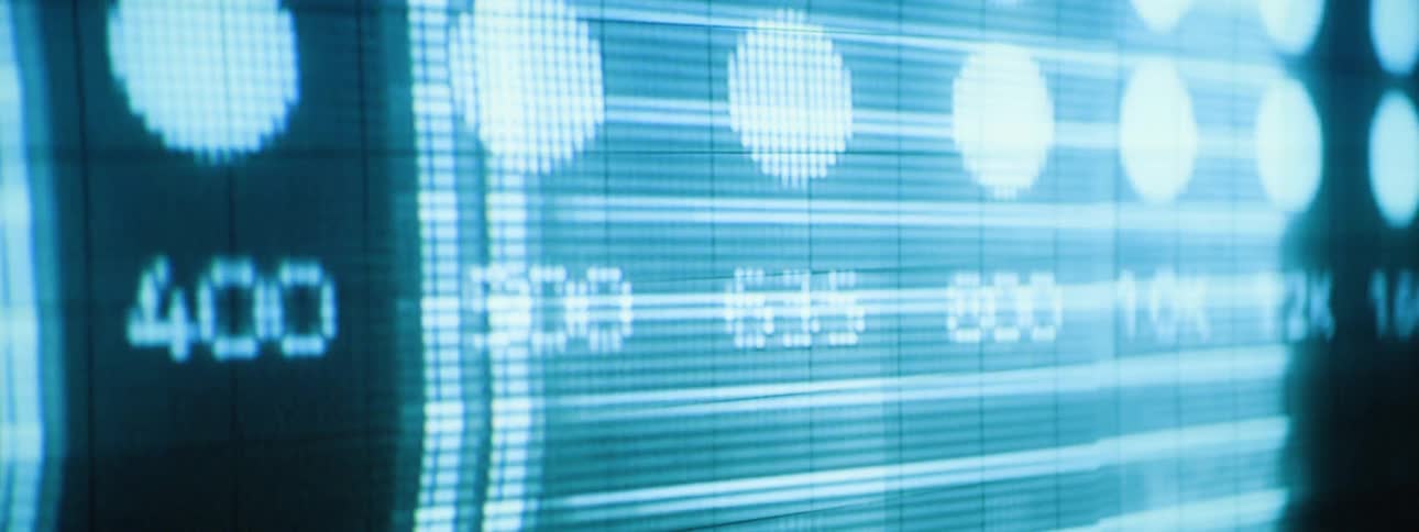 A digital display screen shows illuminated blue circular patterns and numerical data on a dark gridded background possibly representing computer data or network activity