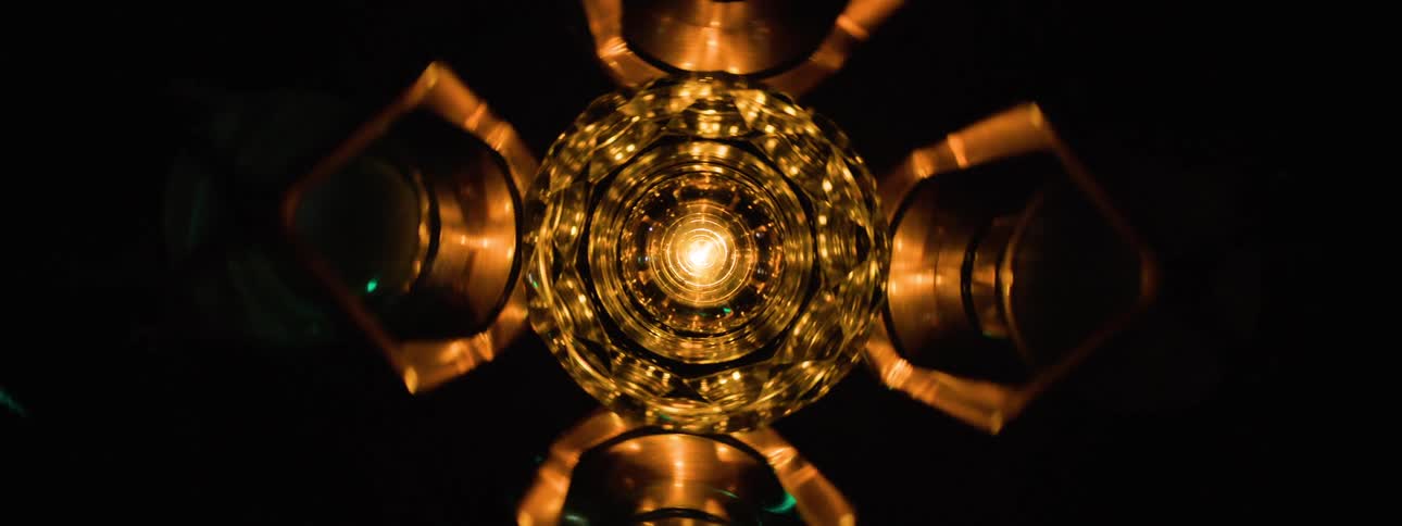 A metal object with flashing lights around it changes speed as it spins