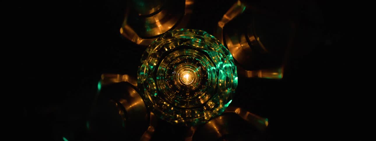 A disco light chandelier mounted on the ceiling spinning and flickering colorful lights across the room