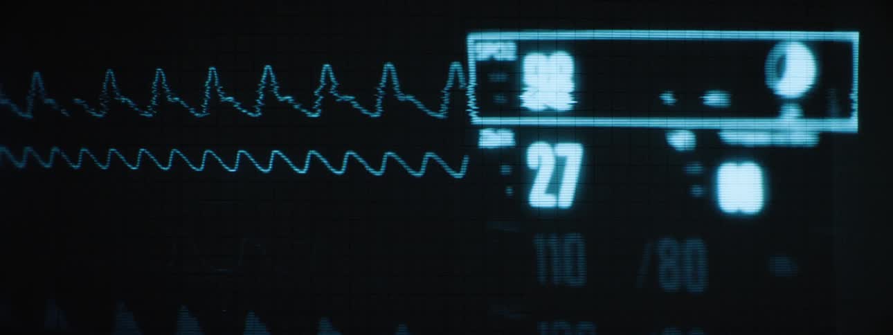 A hospital monitor displays vital signs including oxygen saturation heart rate and respiratory rate