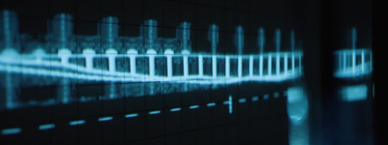 A dark screen displays a bright blue waveform fluctuating across a grid with various markers and dashed lines