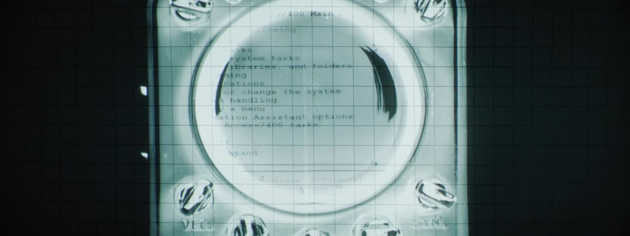 Sheets of information flash from a projector on the wall