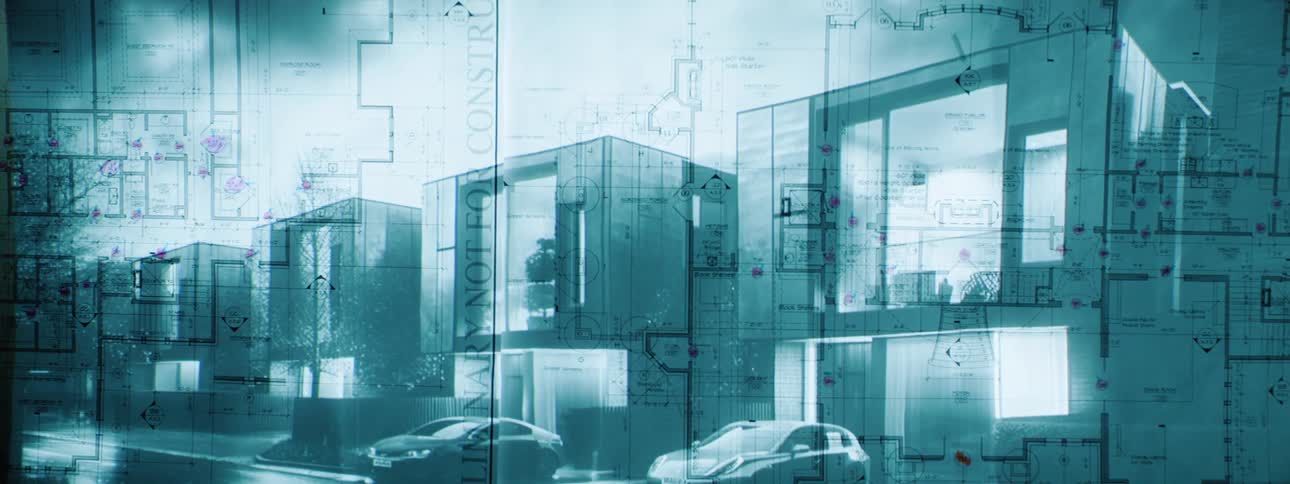 Architectural blueprints of modern residential buildings are superimposed over a slightly blurred nighttime street scene with parked cars and wet pavement