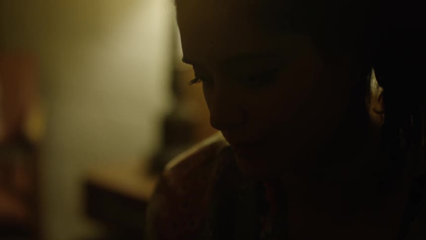A person is looking down in a dark room