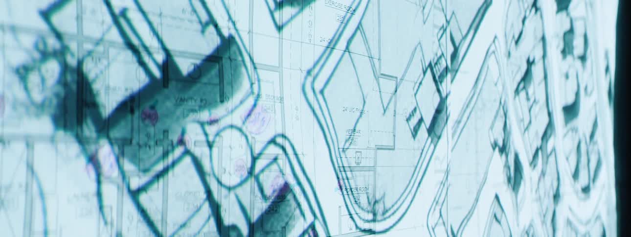 Overlapping architectural blueprints detail room layouts and dimensions