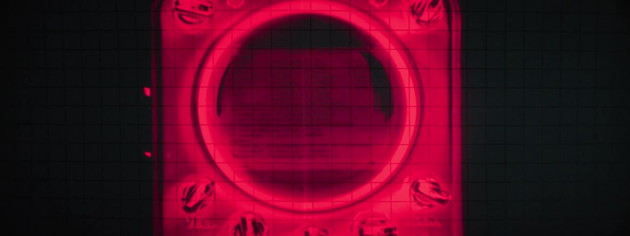 Closeup shot of a redlit electronic device possibly a multimeter or control panel