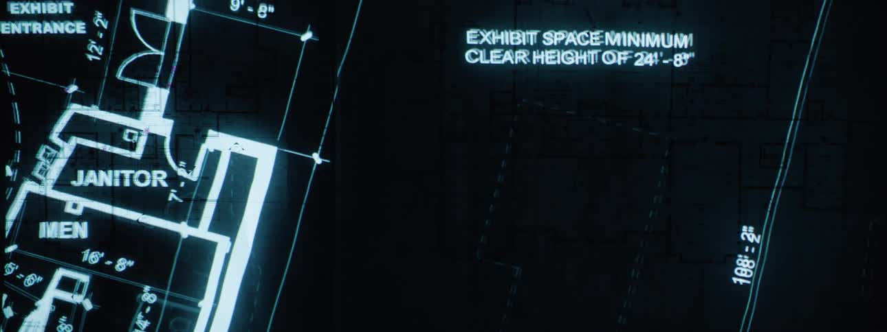 An architectural drawing of a series of buildings with plans displayed on a monitor screen