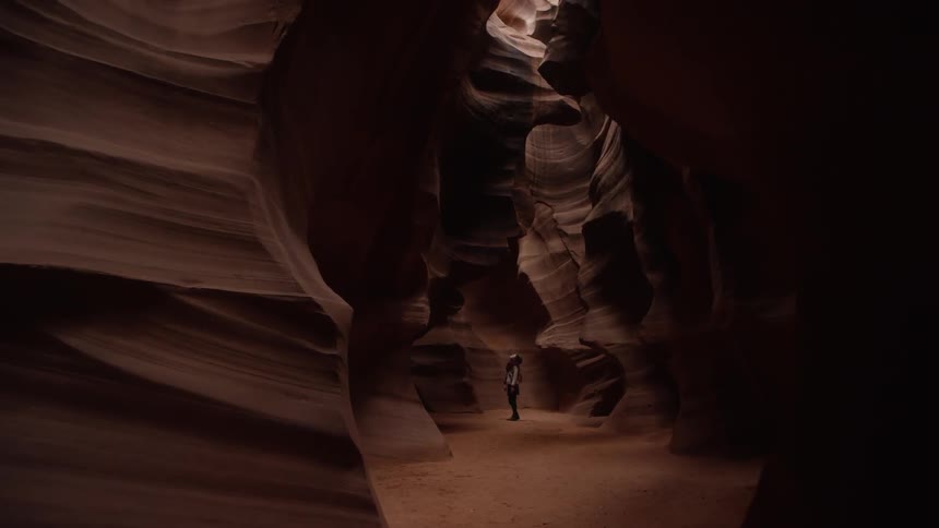 A person is standing in the distance in this cavern
