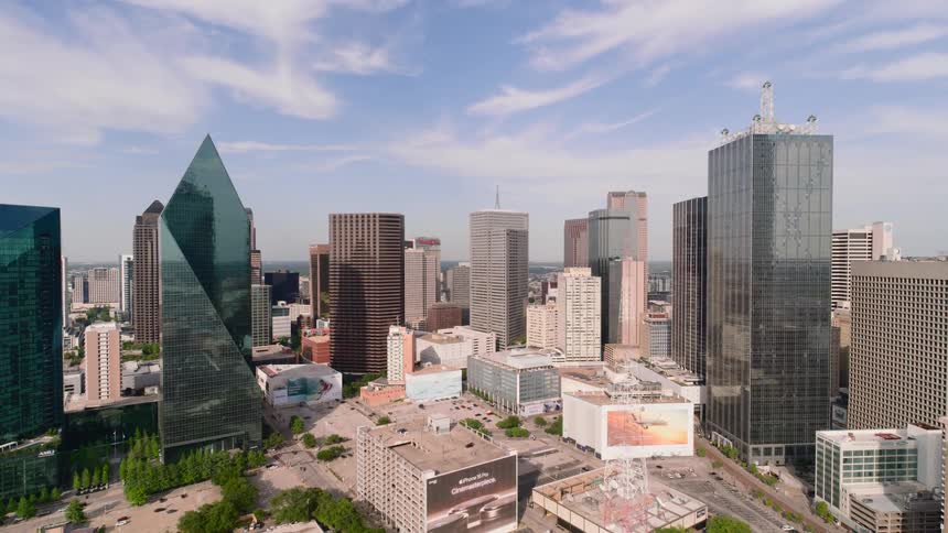Aerial shot of downtown with large illuminated skyscrapers