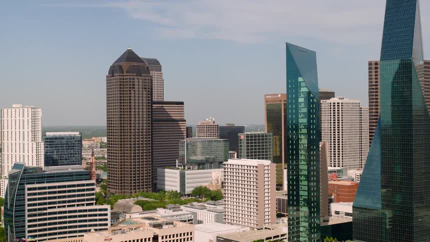 A city skyline with a series of skyscrapers and highrise buildings on a sunny day