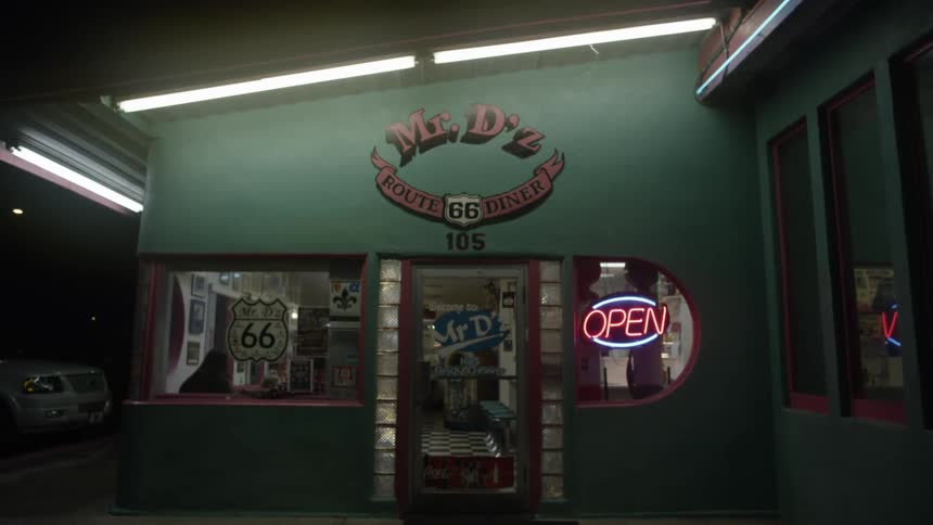 A store has a neon open sign at night