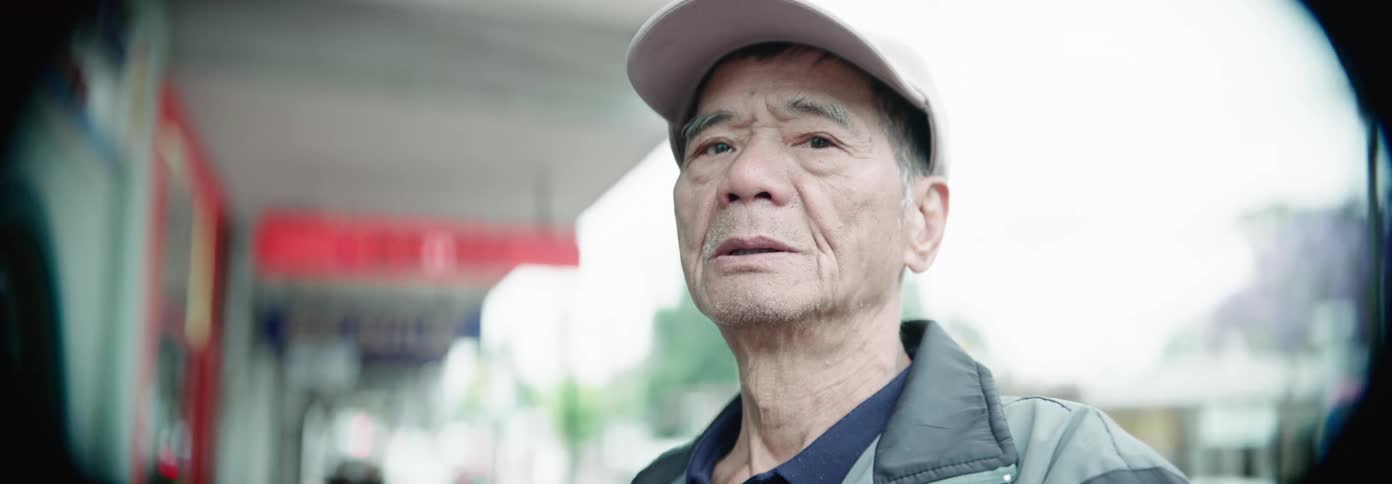 A man is standing outside by a store