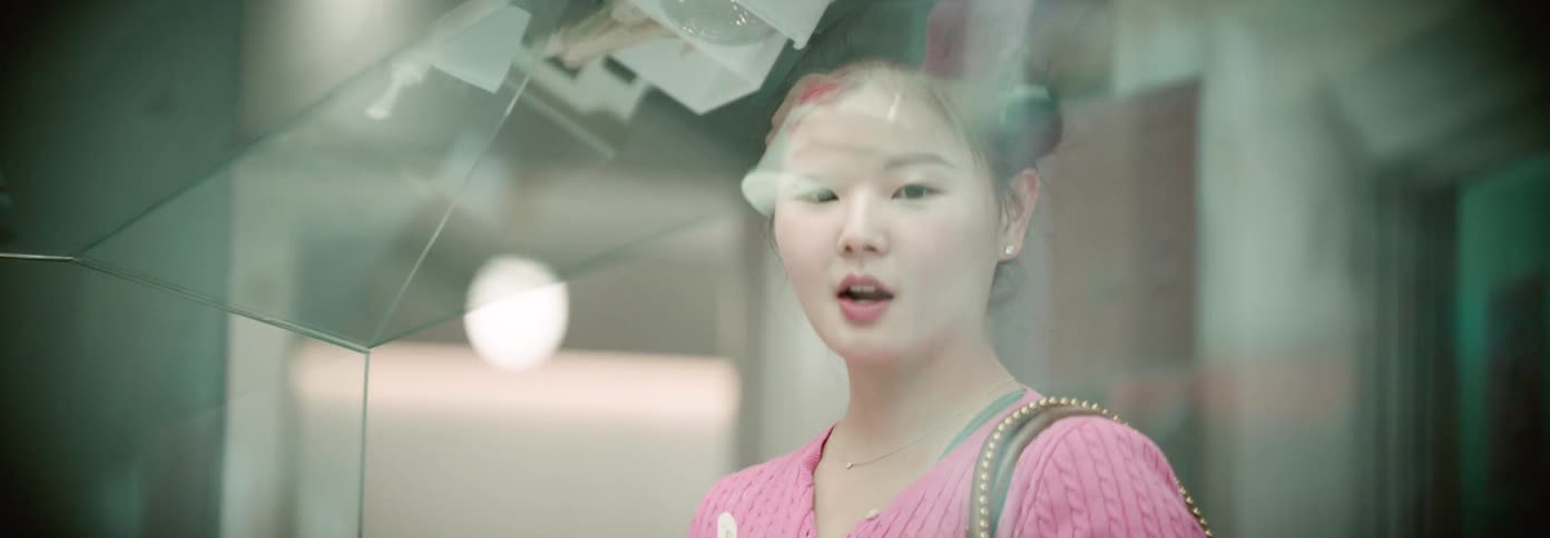 A girl is eating behind the glass window
