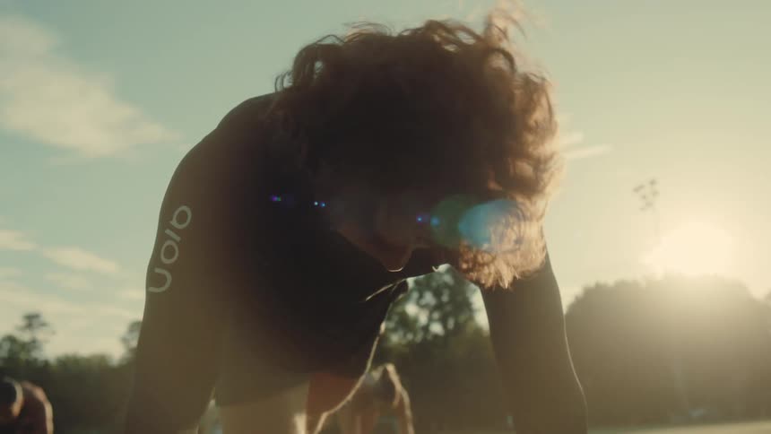 People on an outdoor sports field doing physical activity