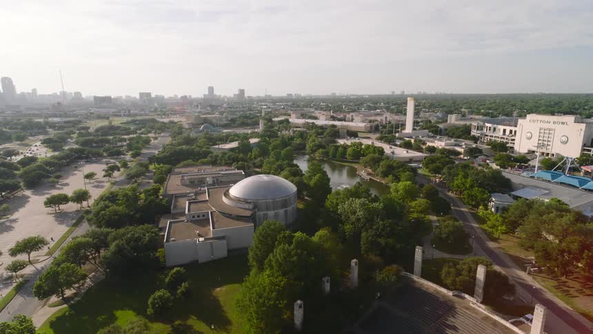 Aerial view of fair park in dallas featuring the planetarium cotton bowl stadium and surrounding greenery