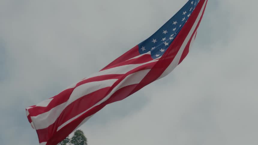 Flag of america blown by winds at daytime