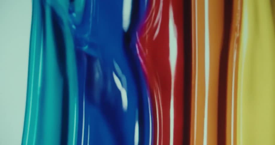 Wide vertical stripes in each rainbow color drip down slowly and slightly overlap one another