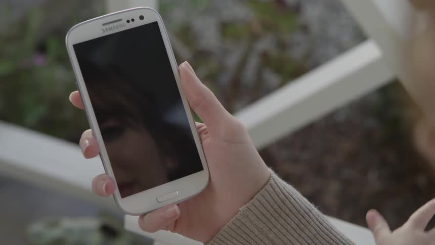 A woman looks at her phone but its not even on