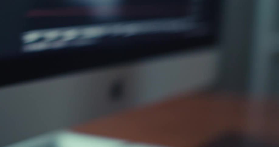 A man sits at a computer and calculates a number