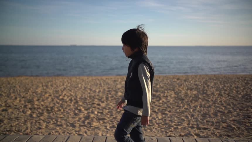 A kids walking on a beach