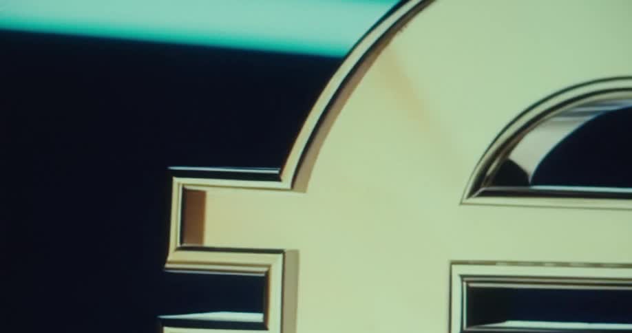 A closeup of a shiny golden euro sign spinning