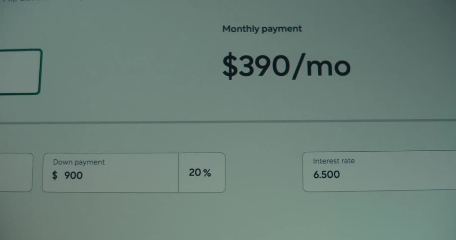 A person enters information about a homes price into a website to determine their monthly payment