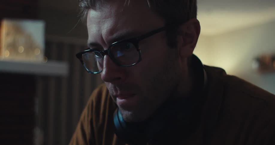 A man in a room focused and determined deep in thought