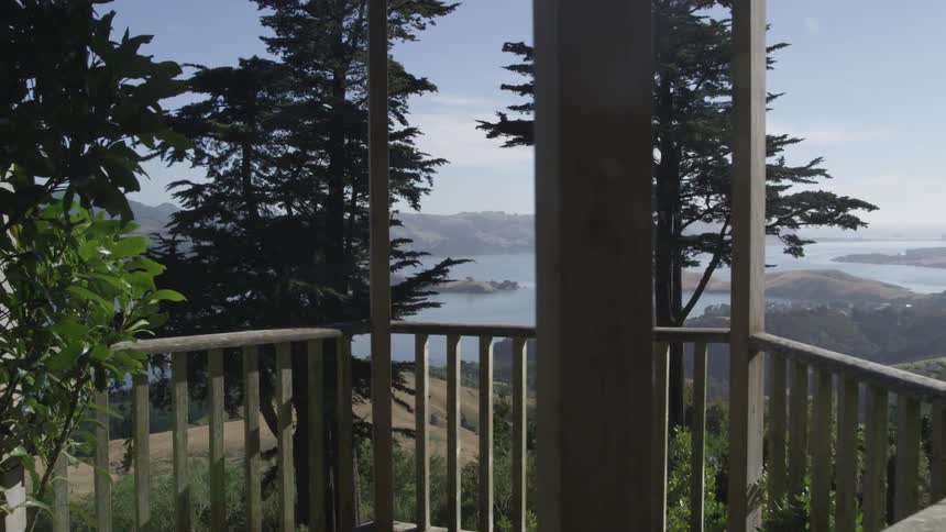 Deck overlooks a lake and mountains