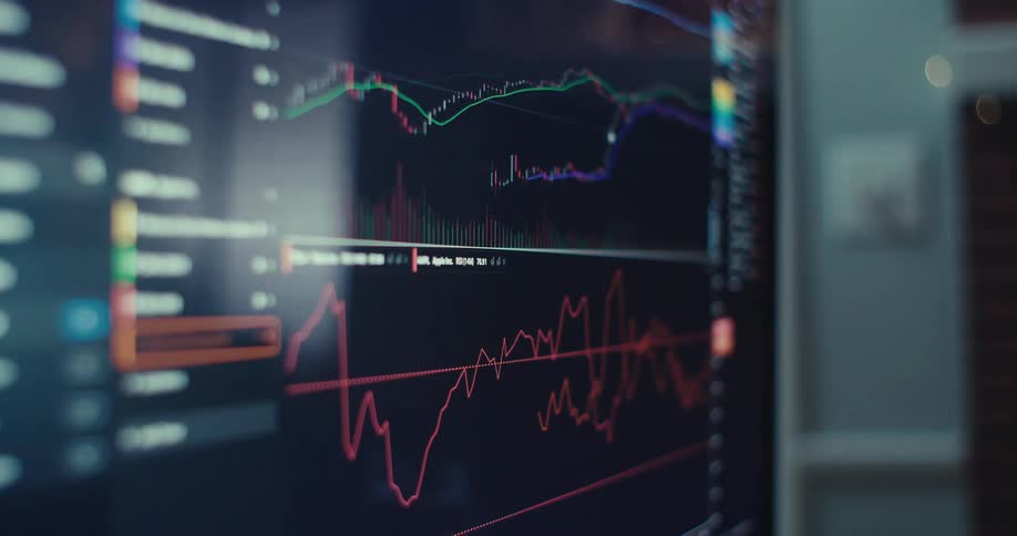 Close up of a monitor screen displaying an operated dark trading interface