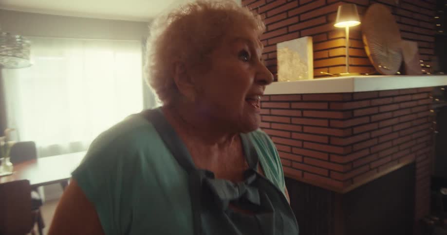 A woman dancing through her living room
