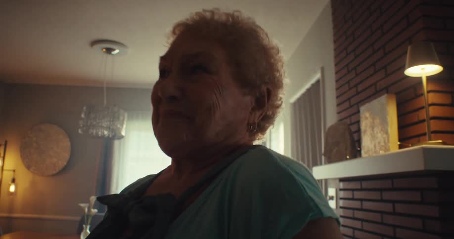 Elderly man and woman dancing and smiling in a room in the morning