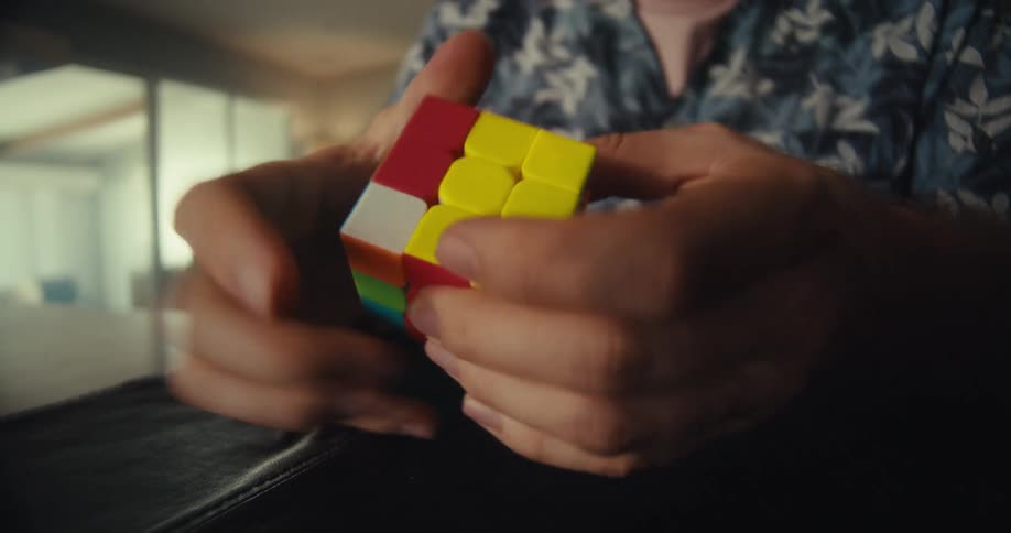 A man is trying to solve the rubiks cube