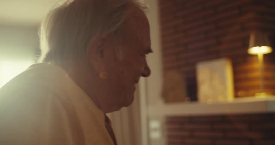 Elderly man and woman dancing indoor at daytime